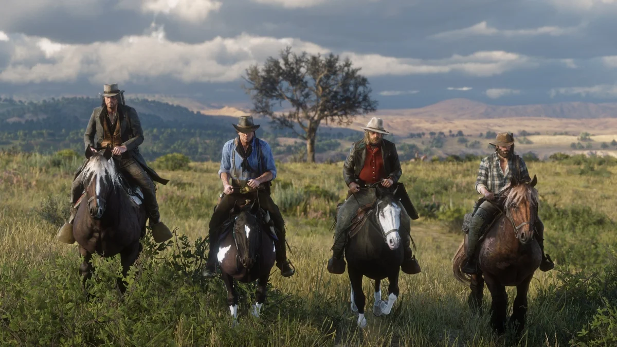 Four riders crossing the rolling hills together
